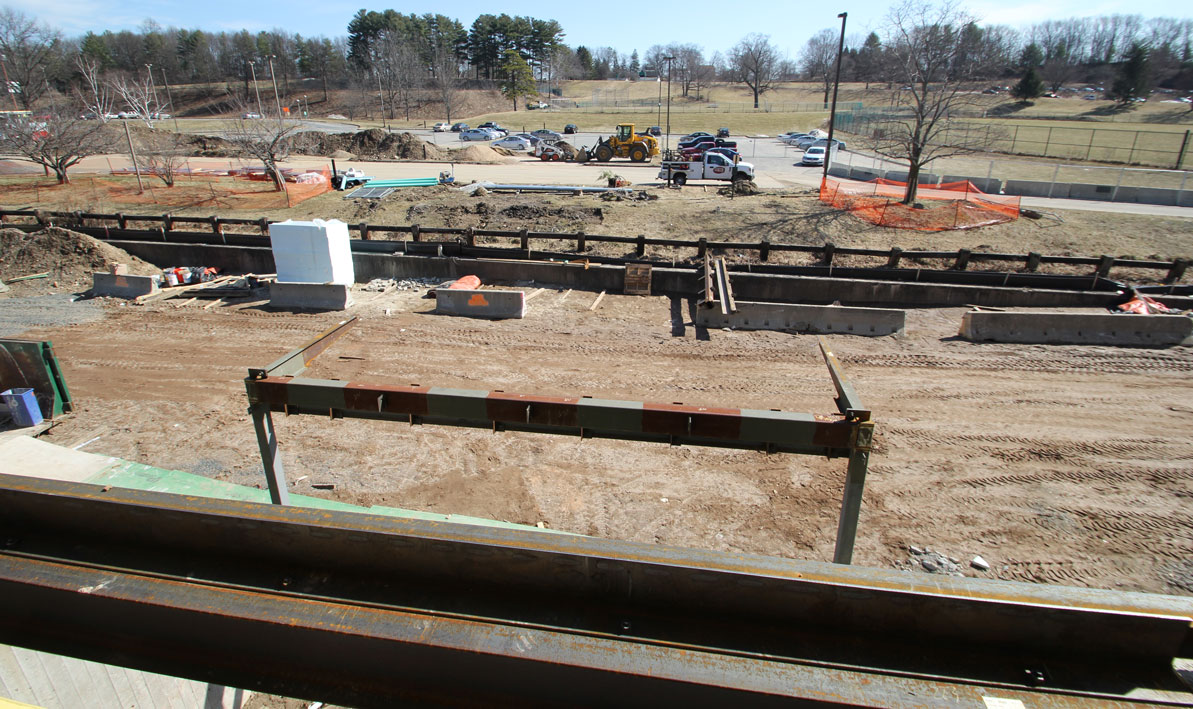 External view of future front door shows frame for new foyer and dirt covering a buried Tannery Brook.