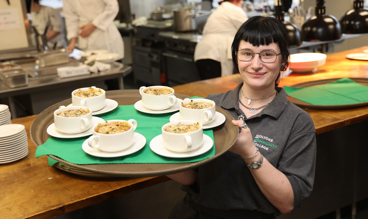 An HCC student seves french onion soup during a lunchtime event at the HCC MGM Culinary Arts Institute. 