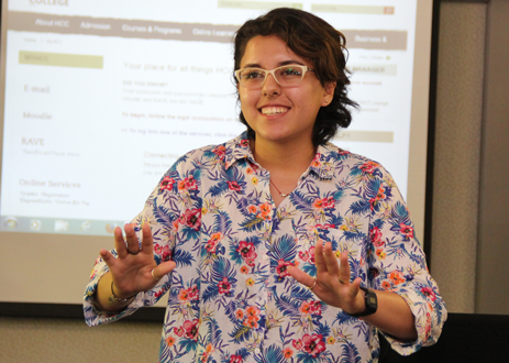 Karianne Santiago smiling in front of a class of students