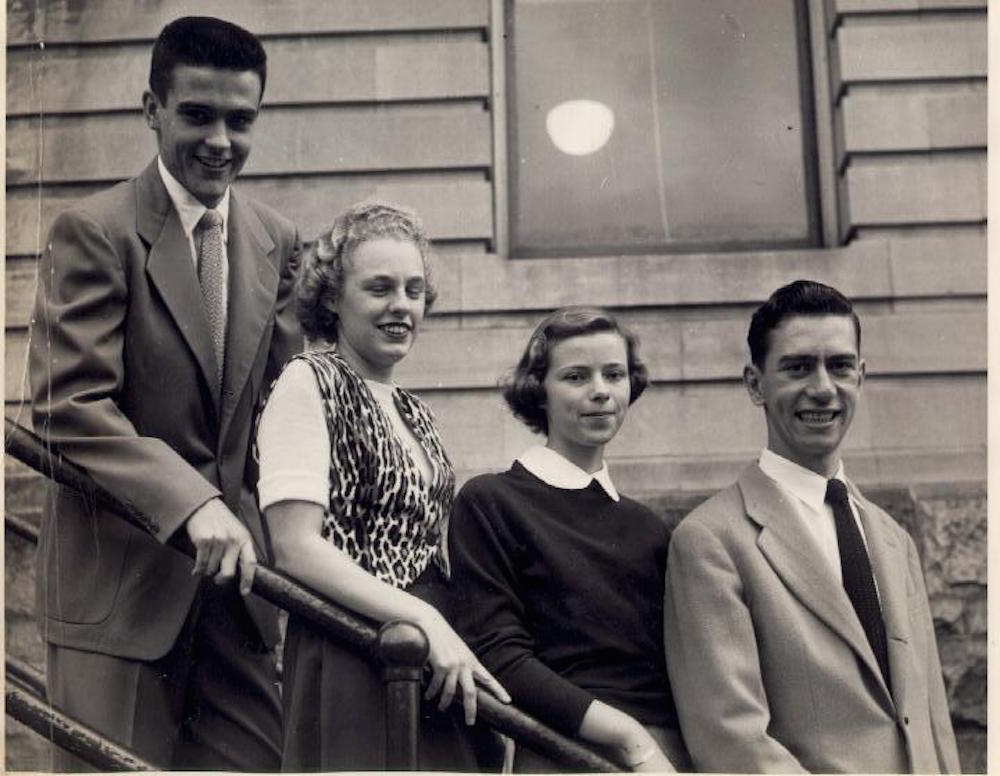 Four people from the class of 1951. Standing from left to right are: William Sullivan, Claire Ducharme, Lucille Brunelle, and Fran Laposta. They are outside but exactly where is not known. Holyoke Junior College.