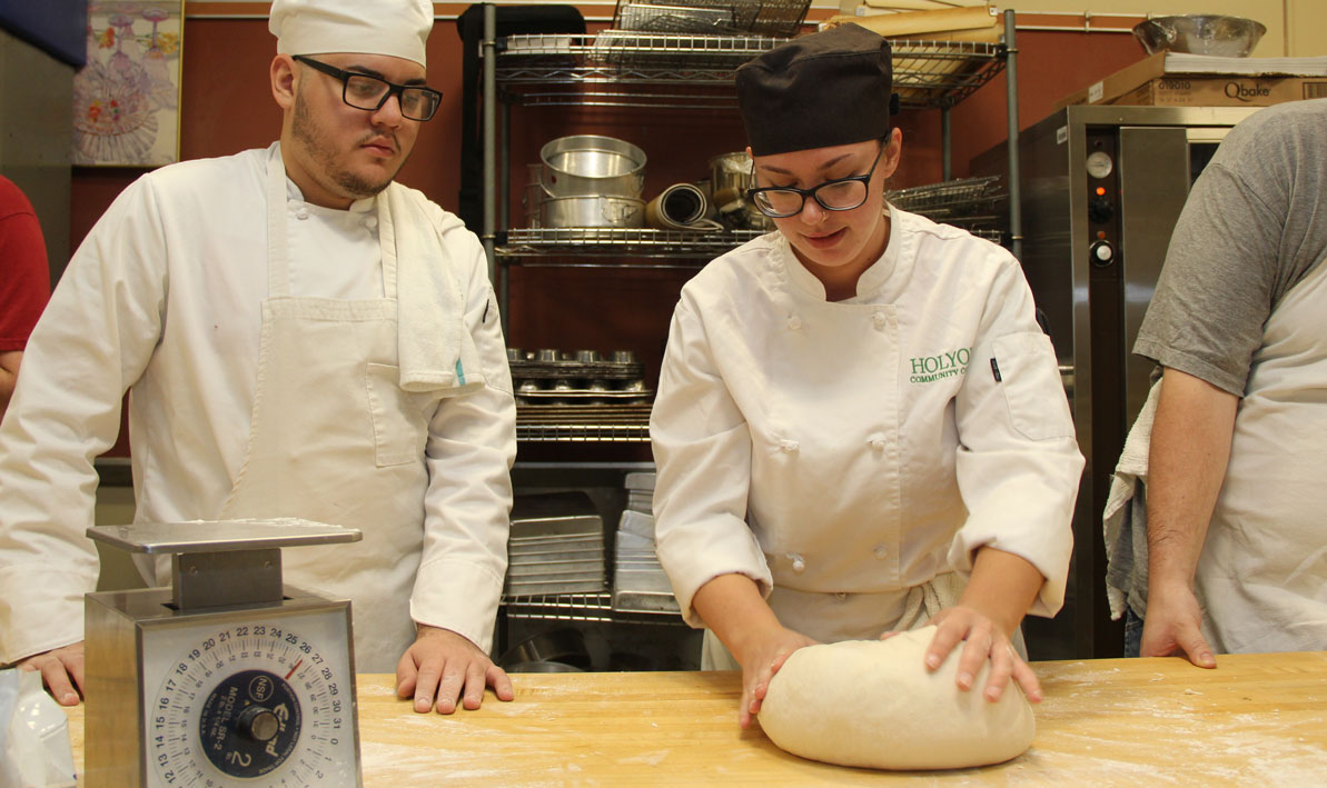 Jessica Labonte '17 demonstrates the proper technique or kneading dough.