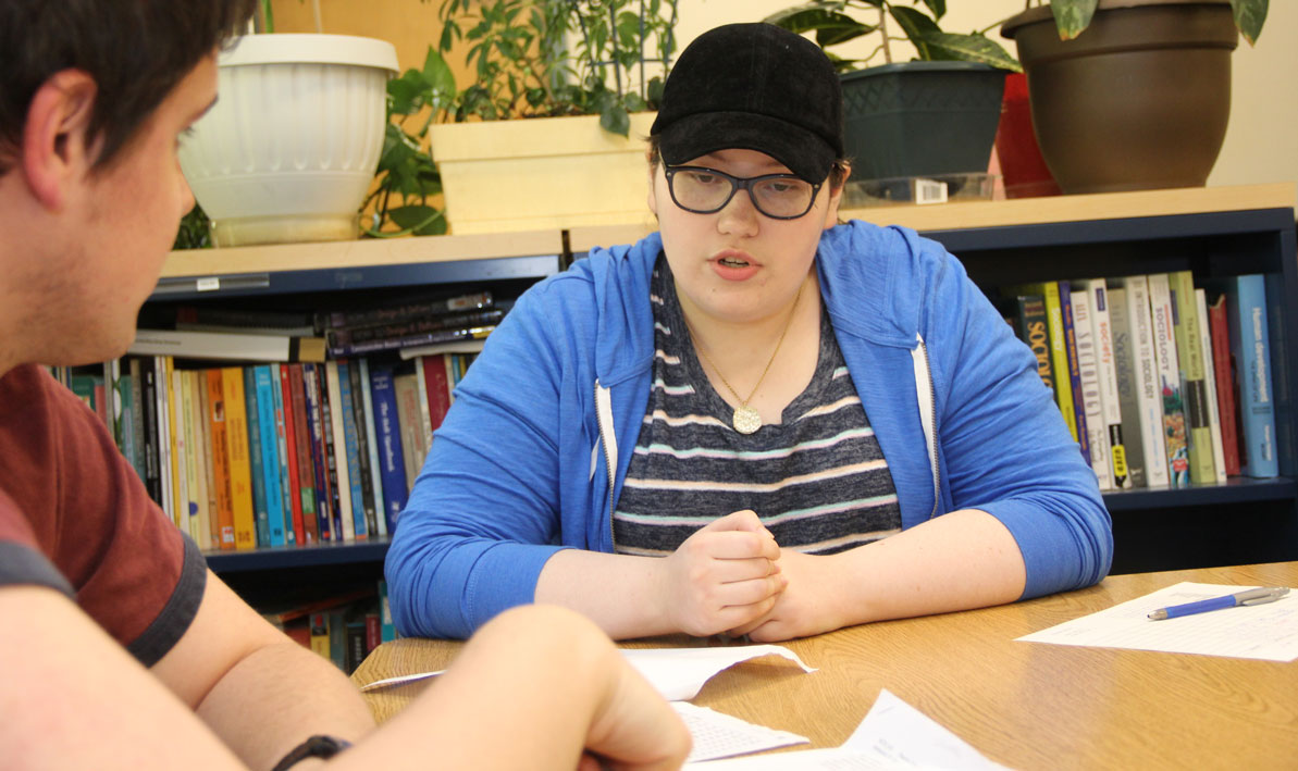 CAPS tutor Andrea Graziano helps a student in the Tutoring Center.