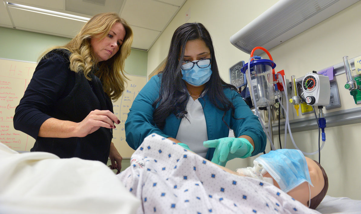 HCC nursing instructor works with student