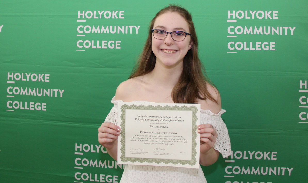 Emilee Boivin holds a scholarship certificate in 2019