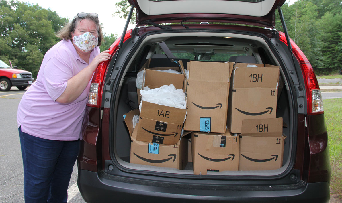 HCC's late dean Moira Maguire displays a trunk load of school supplies for HCC students