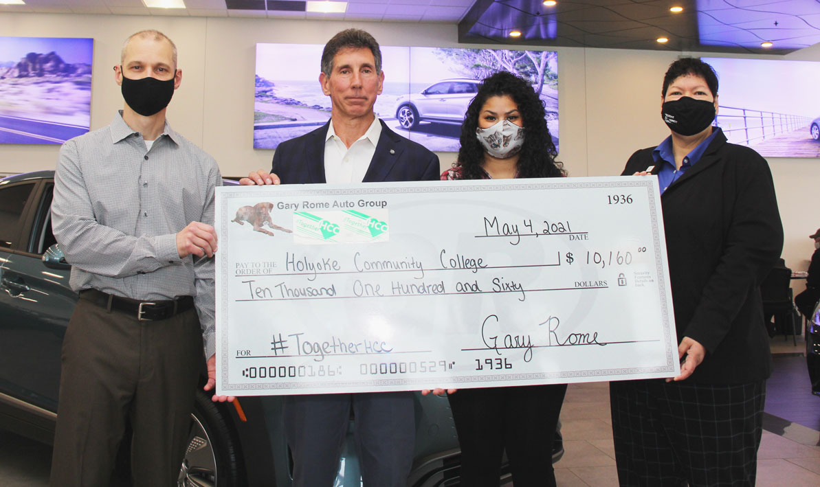 HCC Foundation board chair Corey Murphy, left, auto dealer and HCC Foundation board member Gary Rome, HCC student Carolina Pena, and President Christina Royal hold a ceremonial donation check from Rome at his Hyundai dealership in Holyoke in May 2021.