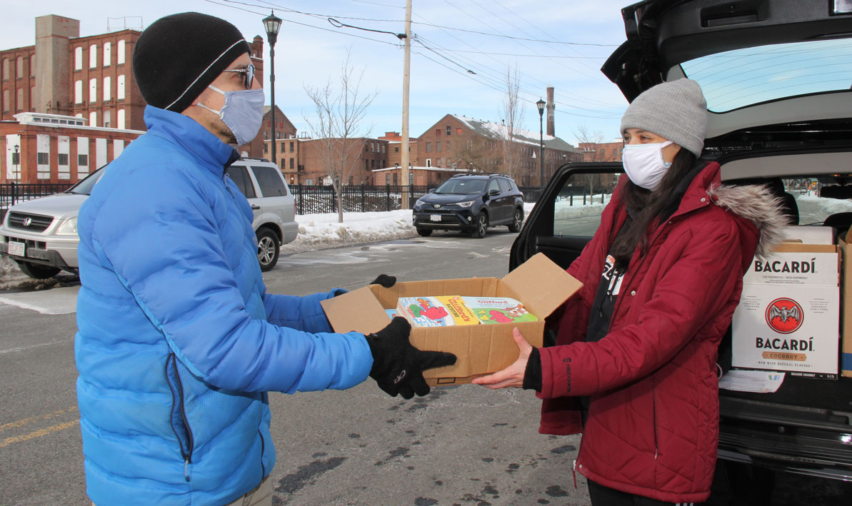 HCC math professor Nick Schwab donates a box of children's book.