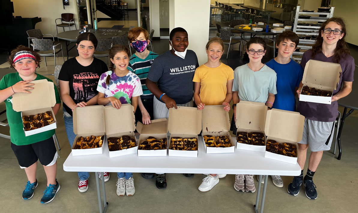 Students in HCC's Culinary Arts Summer Youth Culinary Arts program show off the eclairs they made during the baking portion of their class.