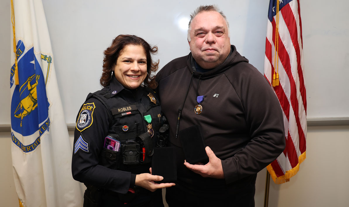 HCC police Sgt. Jackie Robles-Cruz and recently retired police officer Robert Wheeler hold their medals of honor.