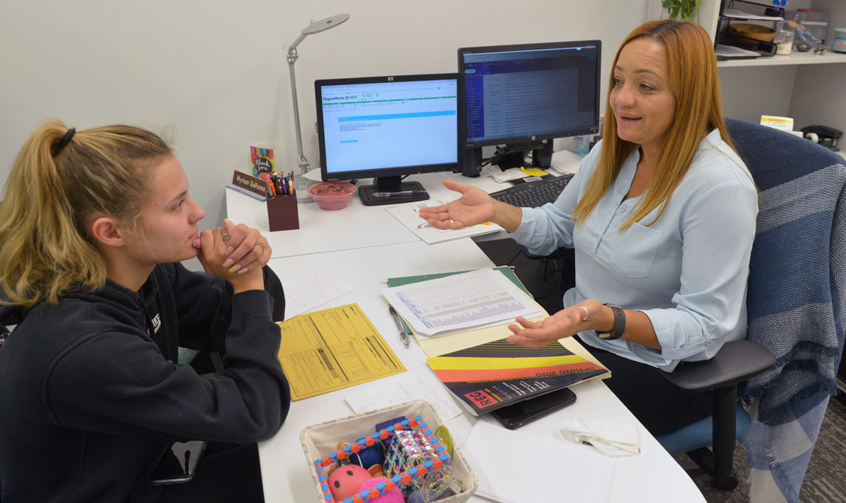 Myriam Quiñones talks to a student in her office at HCC.