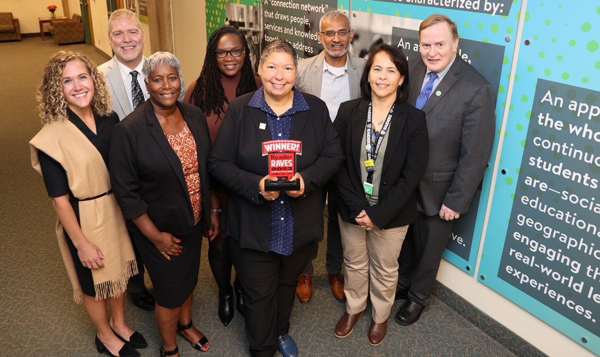 President Christina Royal, surrounded by the HCC Cabinet, holds the Readers Raves Award for Best College or University