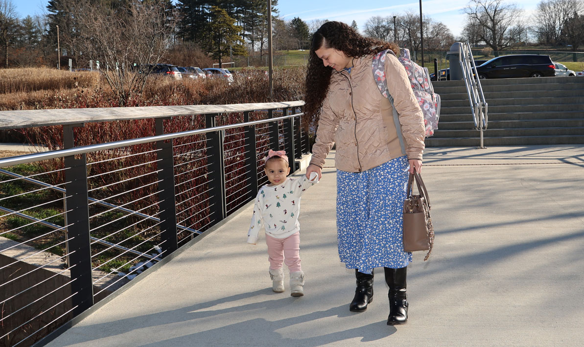Alondra Serrano escorts her daughter, Anna, into the Campus Center. 