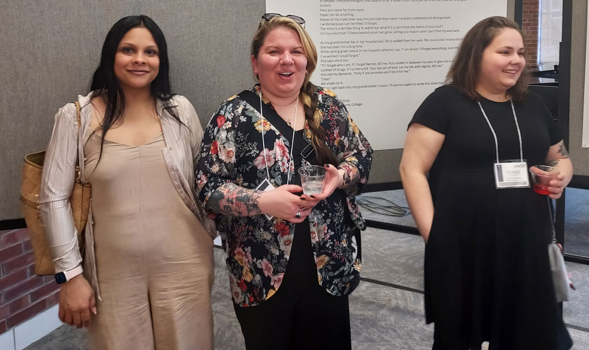 HCC students Bianca Lopez, Angela Tindell-Gula, and Rachel Reynolds stand in front of their poems at Westfield State University