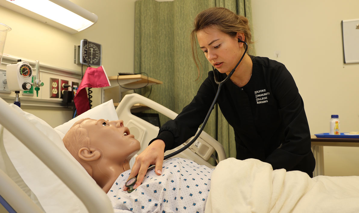 Nursing student Gabriela Artin checks the vital signs on a patient in the HCC Simulation Center.
