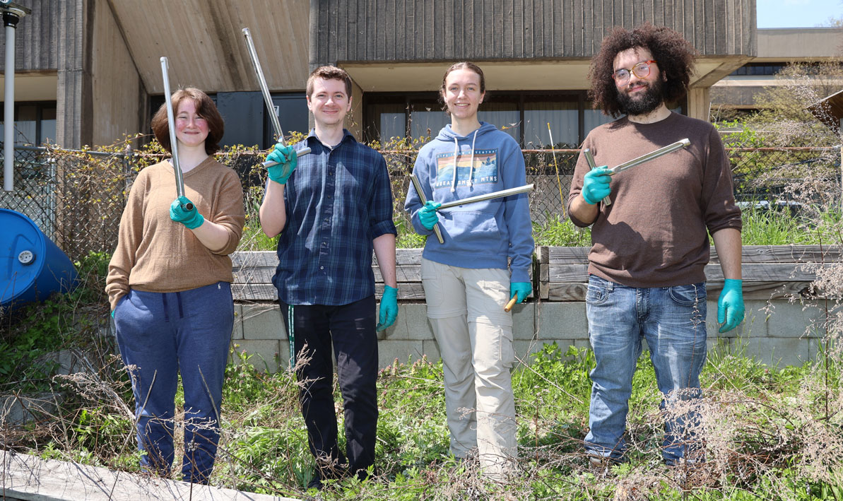 Karlie Moriarty, Mitchell Sadowski '19, Lindsey Dion, and Darlos Robles get ready to take soil core samples in the Sustainability Garden