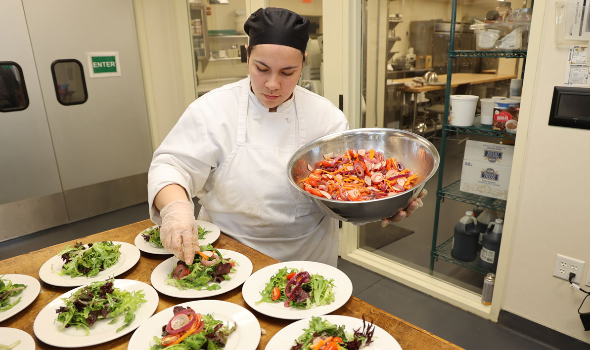 Student plating salad