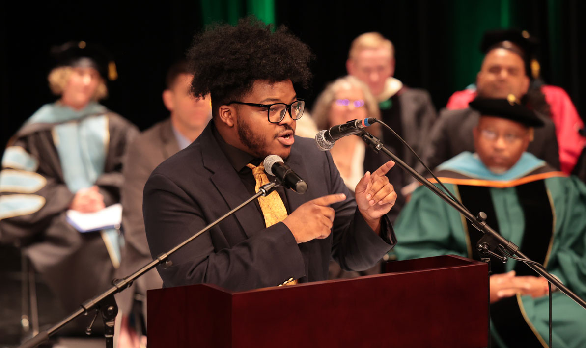 HCC music major Kyren Harris performs his original poem 'First Letter" during the inauguration of President George Timmons.
