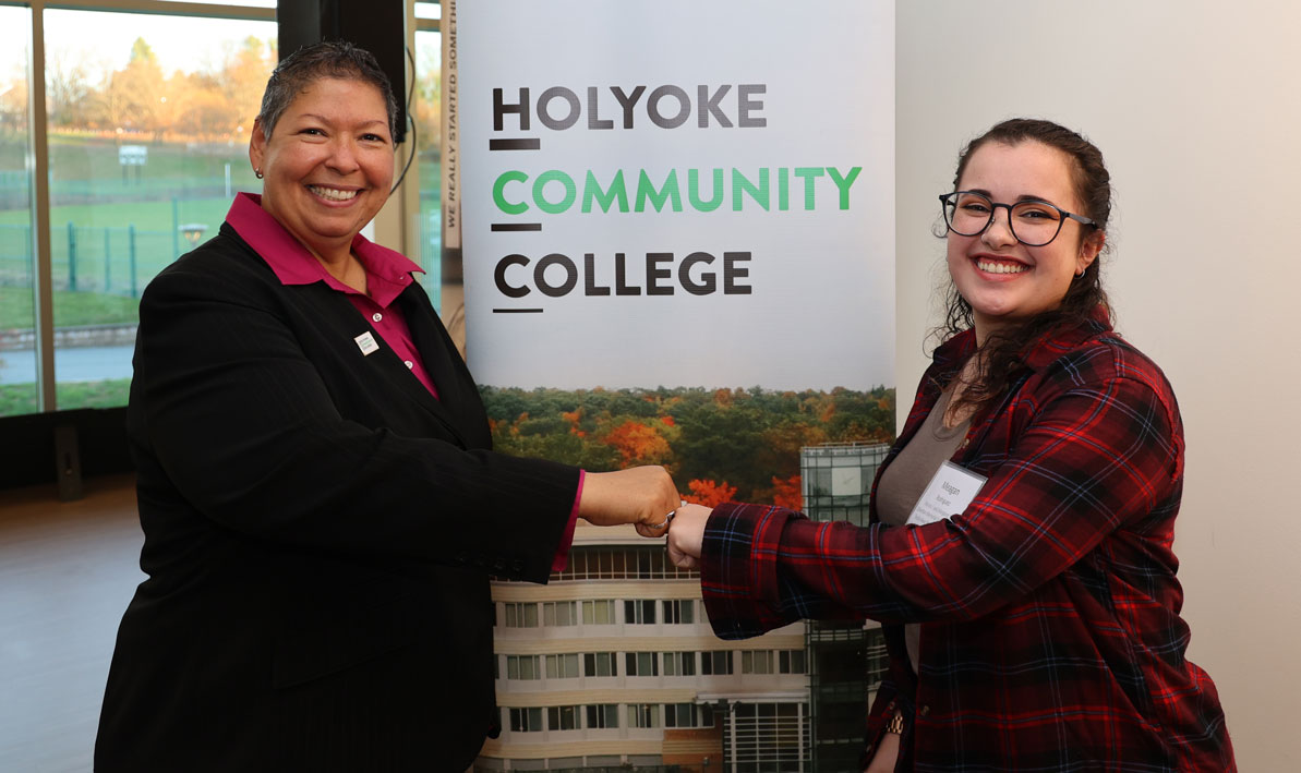 President Christina Royal bumps fists with HCC Foundation scholarship recipient Meagan Rodriguez