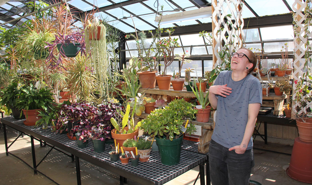 Student Avery Maltz takes care of the HCC greenhouse