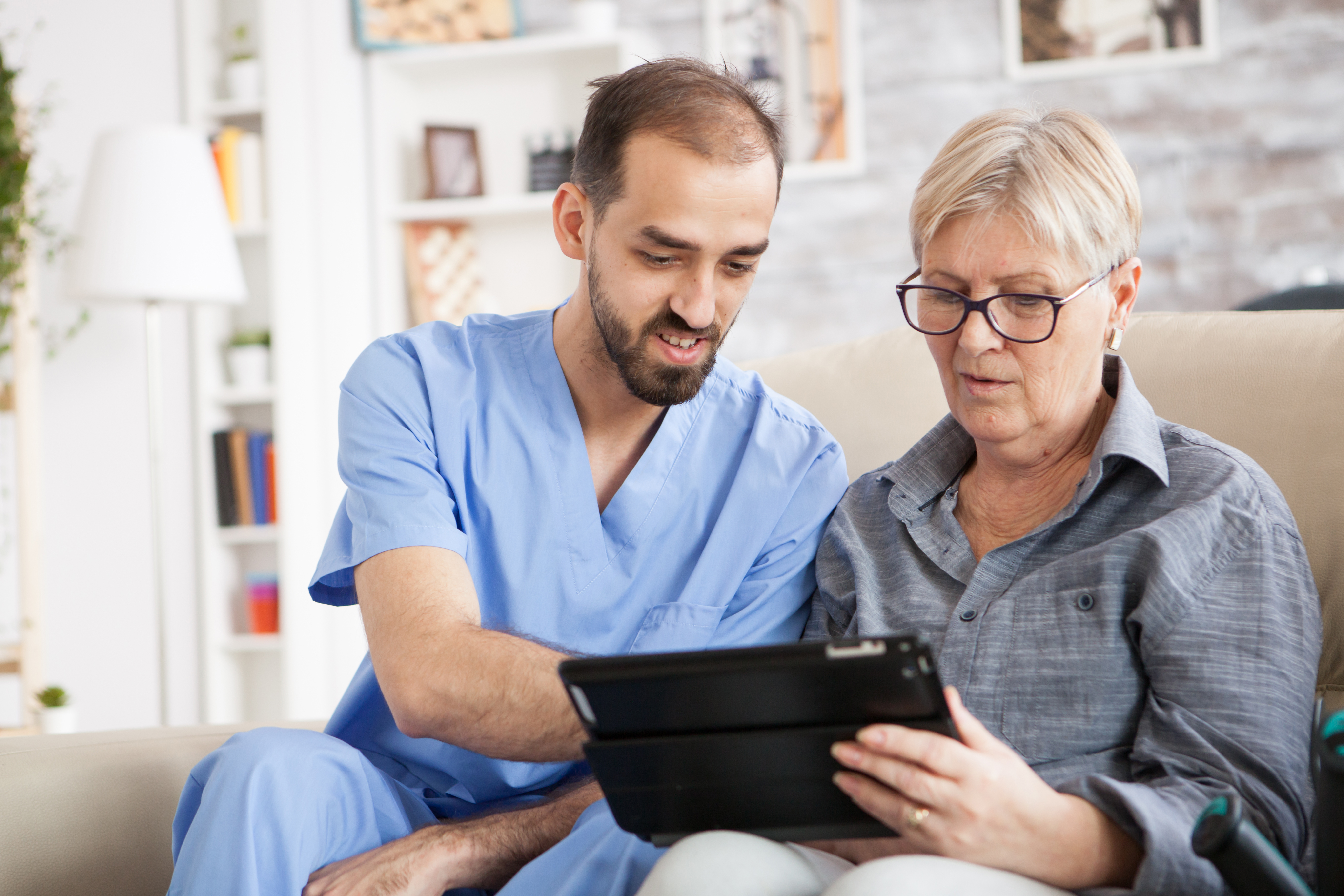 A behavioral health associate chats with a patient