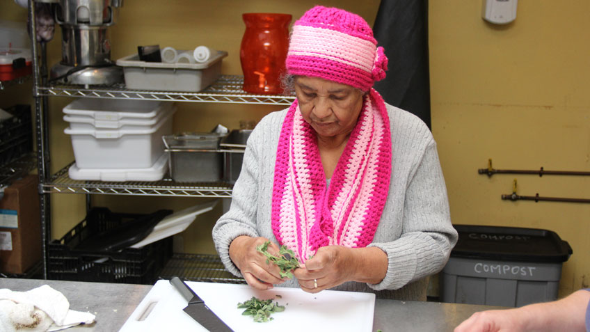 Miriam Gonzalez of Springfield prepares fresh oregano. 