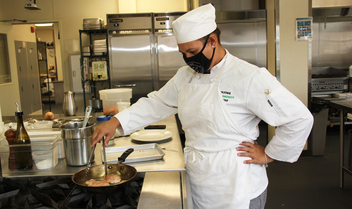 Monica Herandez of Westfield pan sears a chicken breast during her Fundamentals of Cookery class at the HCC MGM Culinary Arts Institute.