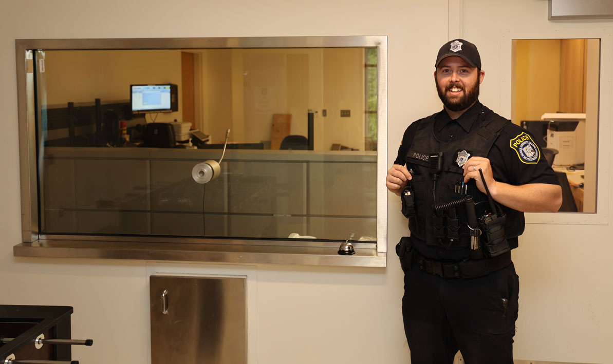 atrol officer Brandon Garvey, stands in the vestibule outside the new Campus Police headquarters.