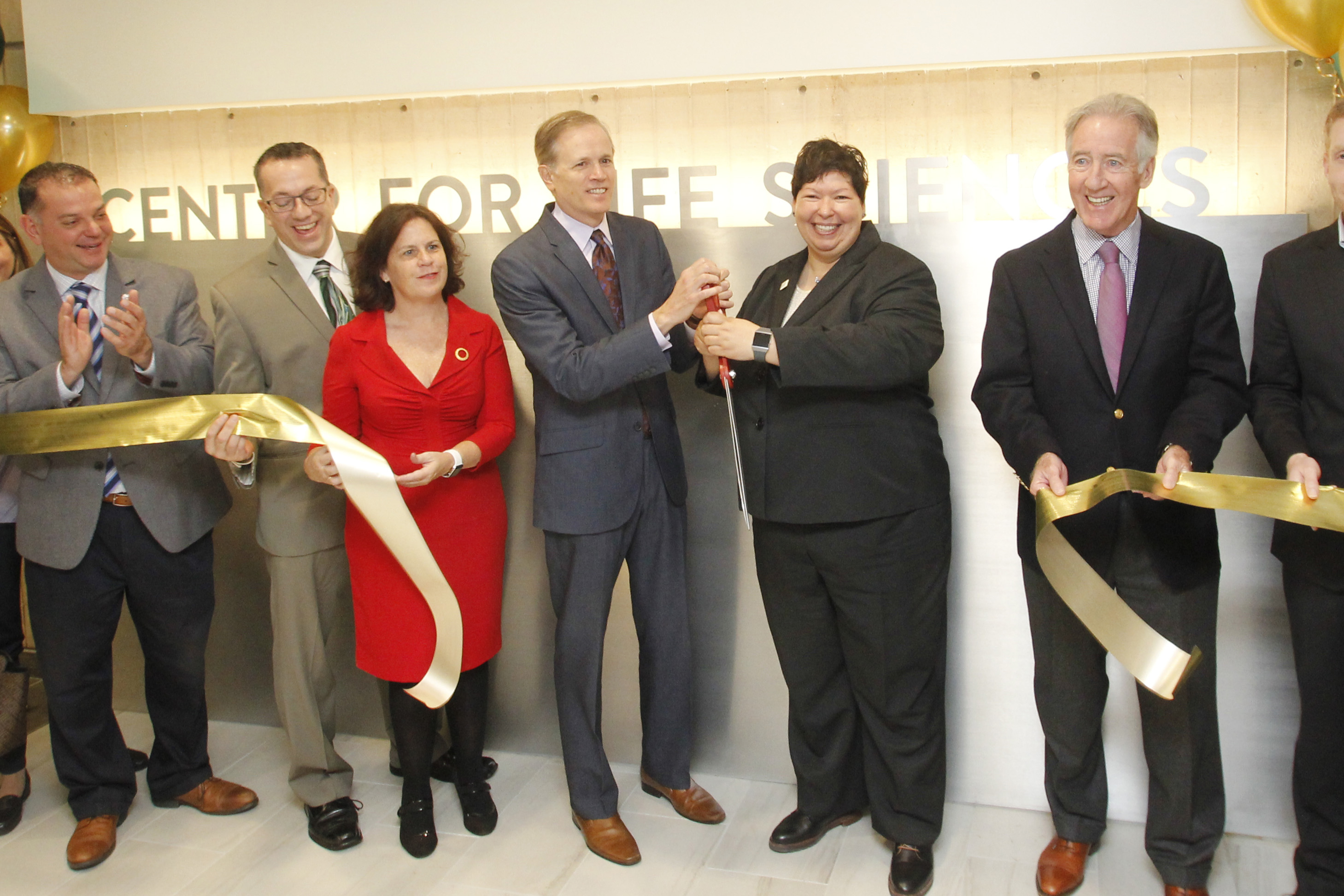 A photo of HCC president christina royal cutting the ribbon for HCC's new Center for Life Sciences