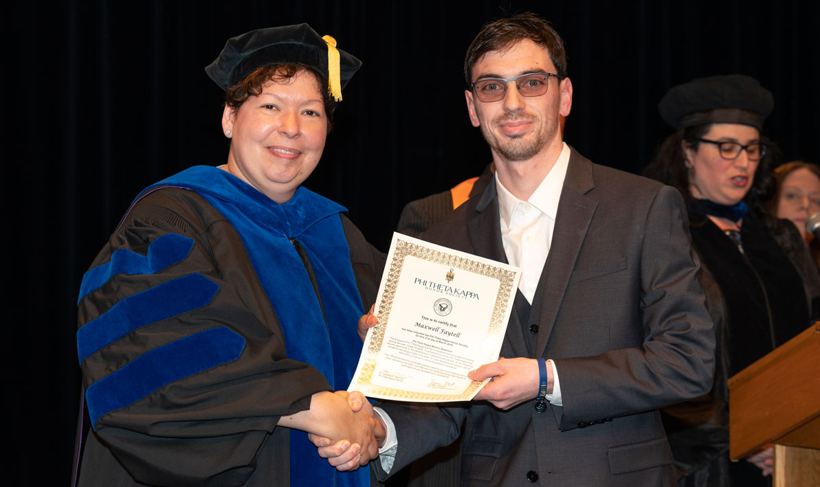 President Christina Royal and HCC student Maxwell Faytell