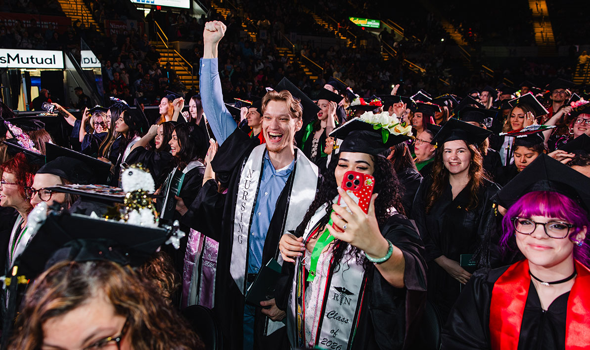 A new graduate celebrates Commencement 2026