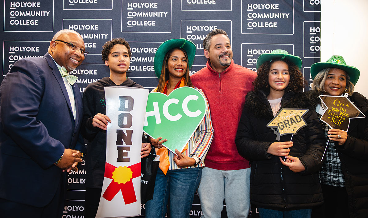 President George Timmons celebrates Fall 2024 Graduate Reception with a new graduate and her family.