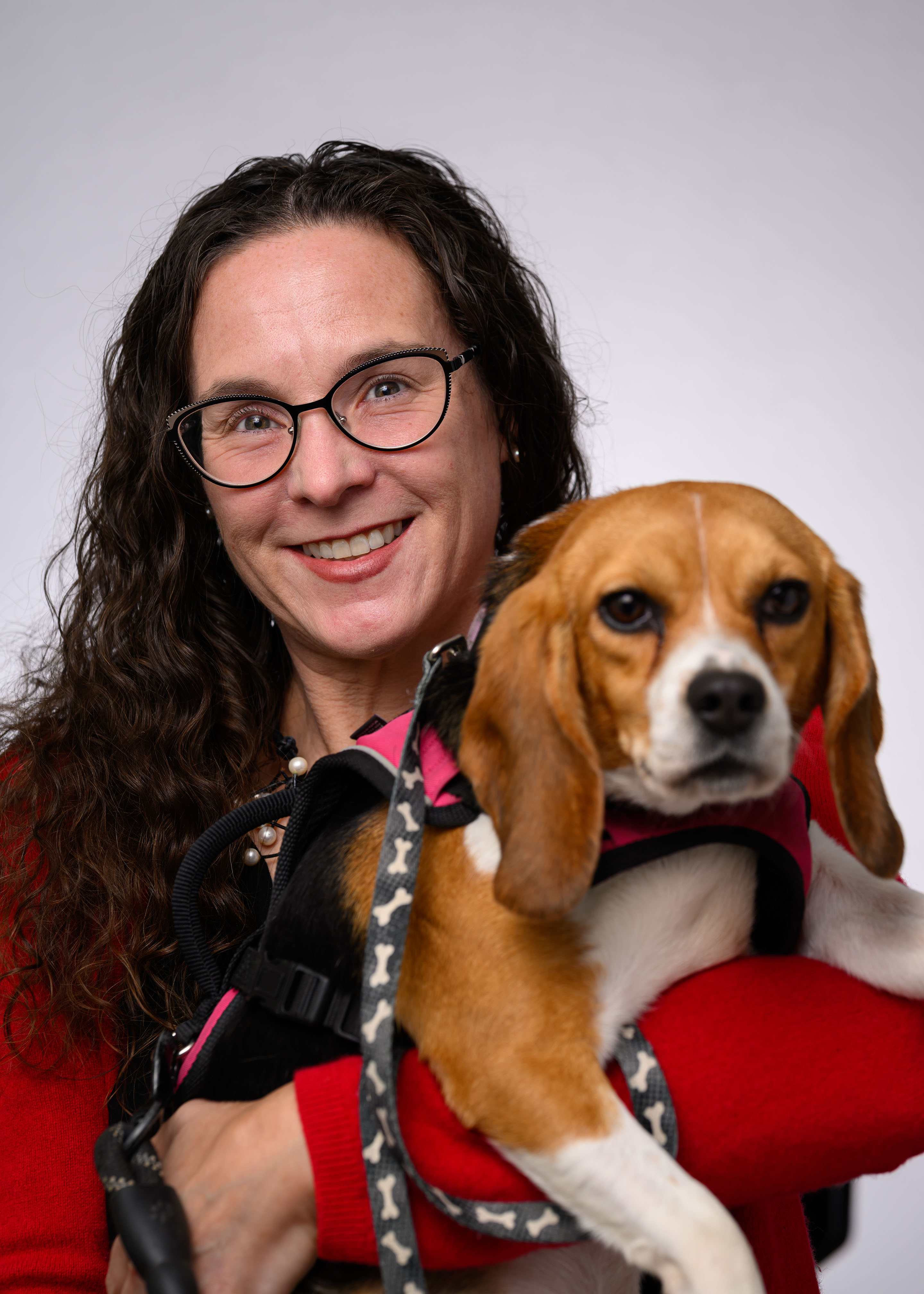 Jennifer York with a small dog sitting on her lap