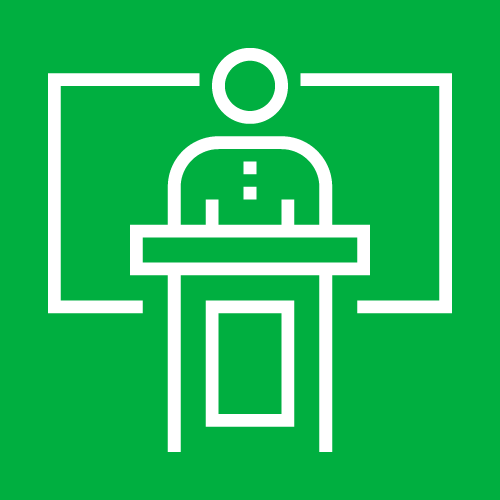 A white line drawing of a teacher pointing to a blackboard on a green background